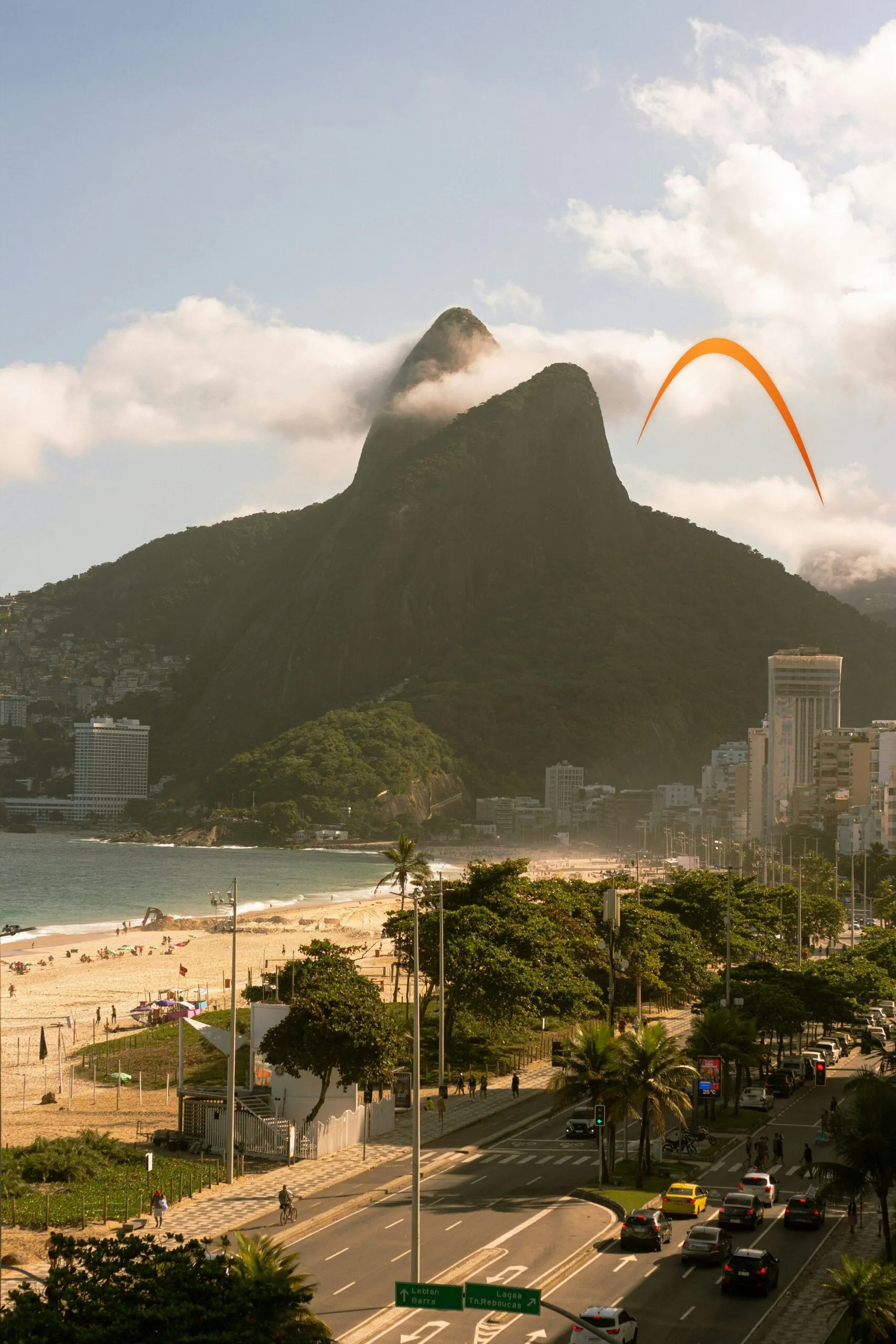 Dois Irmãos mountain in the clouds, Rio de Janeiro, with the orange Gen Brasil arch